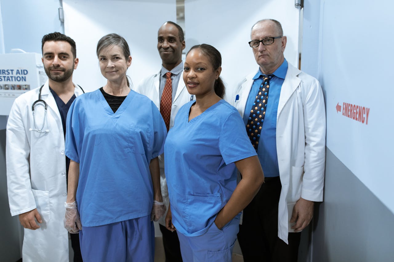 our-story-02 A diverse group of healthcare professionals in hospital uniforms, showcasing teamwork and diversity.